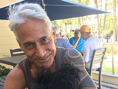 Why did Olympic diving icon Greg Louganis sell his medals?