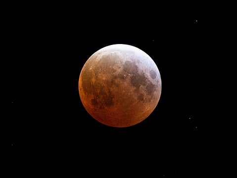 During totality, the moon will not vanish completely but will glow in hues ranging from yellow to deep red.