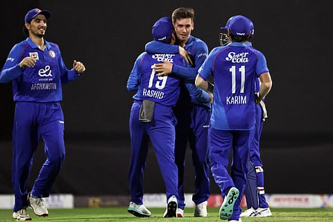 Afghanistan's players celebrate after taking the wicket of Pakistan's Saim Ayub during the T20 international cricket match against Afghanistan and Pakistan in Sharjah on September 7, 2025.