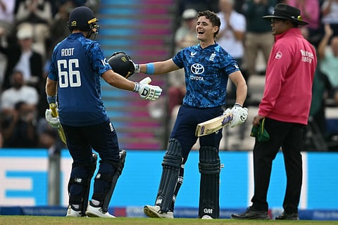 England's Jacob Bethell (C) celebrates reaching his century with England's Joe Root (L) during the third One Day International (ODI) cricket match against South Africa at the Utilita Bowl cricket ground, in Southampton, on the south coast of England on September 7, 2025.