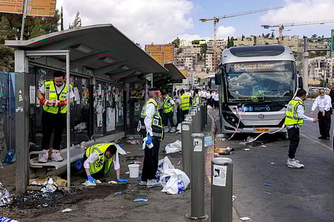 Members of Israel's ZAKA search and rescue emergency services collect samples at the scene of a shooting at the Ramot road junction in Israeli-annexed east Jerusalem on September 8, 2025.