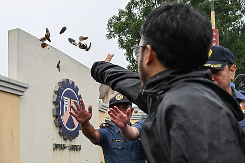 A protester throws green mussels during an anti-corruption rally outside the Philippine Department of Public Works and Highways (DPWH) in Navotas, Metro Manila on September 8, 2025.