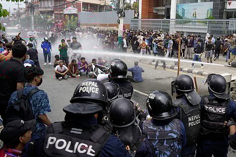 Riot police use a water cannon on protesters outside Parliament in Kathmandu, Nepal.