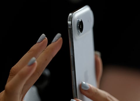 An attendee inspects a new Apple iPhone Air during an Apple special event at Apple headquarters on September 9, 2025 in Cupertino, California.