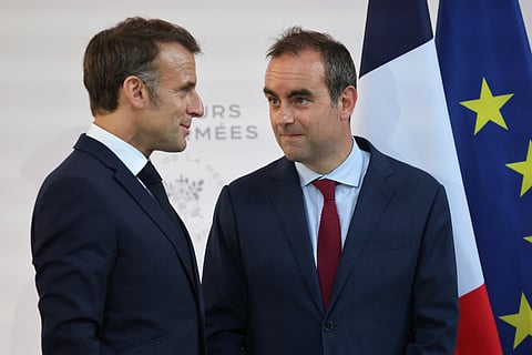 France's President Emmanuel Macron (L) speaks with France's Minister of Armed Forces Sebastien Lecornu after delivering a speech to army leaders at l’Hôtel de Brienne in Paris on July 13, 2025, on the eve of the annual Bastille Day Parade in the French capital.