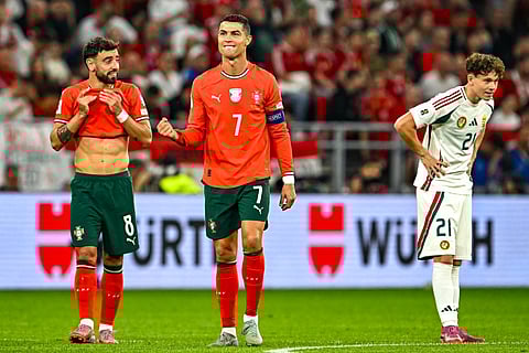 Portugal's forward Cristiano Ronaldo (R) celebrates after scoring the 1-2 penalty goal with Portugal's midfielder Bruno Fernandes (L) as Hungary's midfielder Alex Toth reacts during the 2026 World Cup qualifiers Europe zone group F football match on September 9, 2025 in Budapest, Hungary.