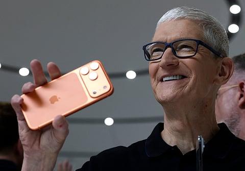 Apple CEO Tim Cook holds up a new iPhone 17 Pro during an Apple special event at Apple headquarters.