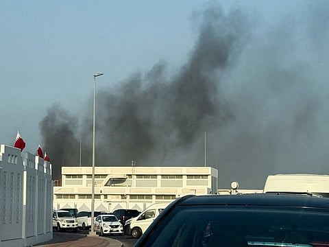 Smoke rises after several blasts were heard in Doha,