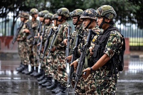 Army personnel stand guard along a street during a curfew imposed to restore law and order in Kathmandu on September 11, 2025.