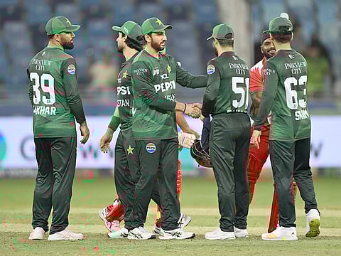 Pakistan's captain Salman Ali Agha (2nd-left) shakes hand with his teammates after winning the Asia Cup 2025 T20 match against Oman at the Dubai International Stadium in Dubai on September 12, 2025.