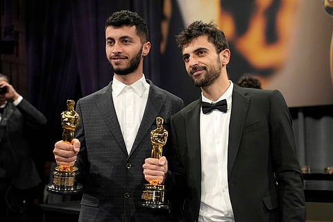 Basel Adra, left, and Yuval Abraham, winners of the Oscar for best documentary feature film for "No Other Land," pose for photos at the Governors Ball, in Los Angeles, March 2, 2025.