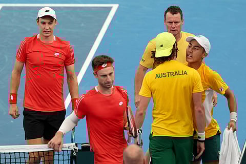 Australia’s team captain Lleyton Hewitt (TOP) watches players Rinky Hijikata (R) and Jordan Thompson react after winning the second set against Belgium’s Sander Gille and Joran Vliegen (L) during their Davis Cup second-round qualifier doubles tennis match at Ken Rosewall Arena in Sydney on September 14, 2025.