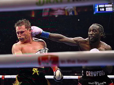 Terence Crawford, right, punches Canelo Alvarez during an undisputed super middleweight championship boxing match in Las Vegas.