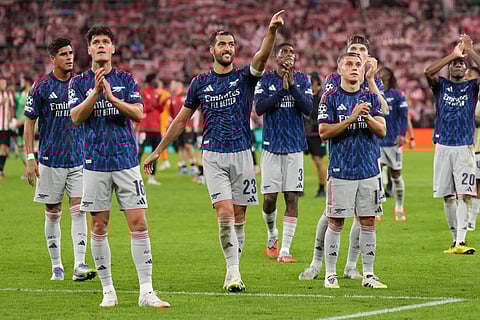 Arsenal players celebrate victory at the end of the UEFA Champions League first round day 1 football match against Athletic Club Bilbao at the San Mames stadium in Bilbao on September 16, 2025.
