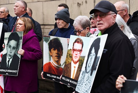 Families of the victims of the 1972 Bloody Sunday, hold a protest outside Belfast Crown court, Northern Ireland, Monday Sept. 15, 2025. (AP Photo/Peter Morrison)