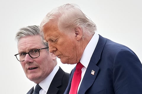 President Donald Trump and Britain's Prime Minister Keir Starmer exit Air Force One as they arrive at Royal Air Force Lossiemouth en route to Aberdeen, Scotland Monday, July 28, 2025.