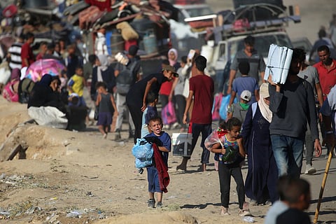 Displaced Palestinians move with their belongings southwards on a road in the Nuseirat refugee camp area in the central Gaza Strip following renewed Israeli evacuation orders for Gaza City on September 16, 2025.