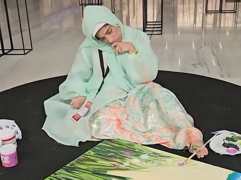 With her foot, Emirati artist defies cerebral palsy and paints a life of colour