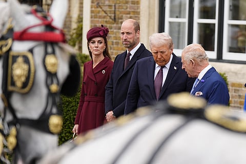 Britain's King Charles III talks with US President Donald Trump, accompanied by Britain's Prince William, Prince of Wales and Britain's Catherine, Princess of Wales, as they await for carriages, after their arrival in the grounds of Windsor Castle, in Windsor, on September 17, 2025, for the start of a second State Visit.