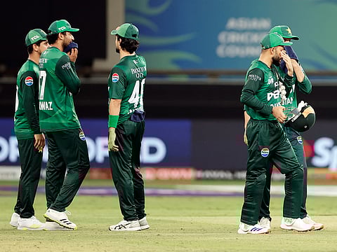 Pakistan's players look dejected after losing the Asia Cup 2025 match against India, at Dubai International Stadium in Dubai on Sunday.