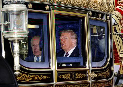 Britain's King Charles III and US President Donald Trump travel in The Irish State Coach during a horse-drawn procession towards Windsor Castle, in Windsor, on September 17, 2025, during a second State Visit.