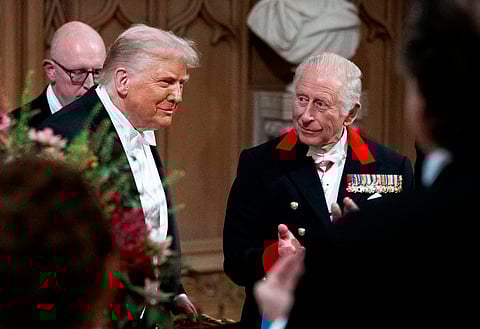 US President Donald Trump (L) reacts alongside Britain's King Charles III after delivering a speech during a State Banquet at Windsor Castle, in Windsor, on September 17, 2025, during the US President's second State Visit.