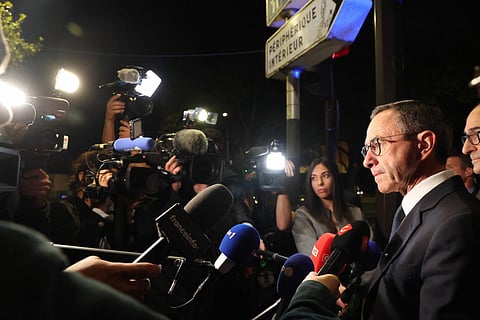 France's Minister of the Interior Bruno Retailleau (R) speaks to the press after meeting with police officers at Porte d'Orléans in Paris on September 18, 2025, prior to a day of nationwide strikes and protests called by unions over France's national budget.