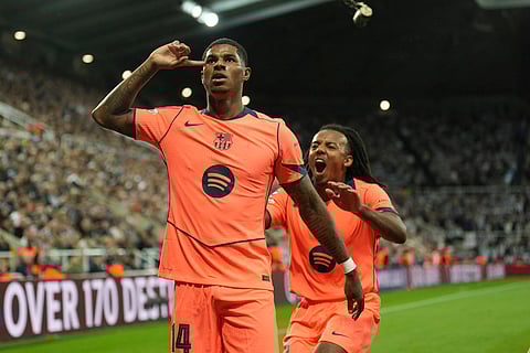 Barcelona's Marcus Rashford, left, celebrates after scoring his side second goal with Jules Kounde during the Champions League, opening phase football match against Newcastle in Newcastle, England, Thursday, Sept. 18, 2025.