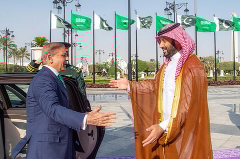 A handout picture provided by the Saudi Press Agency (SPA) on September 17, 2025, shows Saudi Arabia's Crown Prince Mohammed bin Salman (R) welcoming Pakistan's Prime Minister Shehbaz Sharif ahead of their meeting in Riyadh.