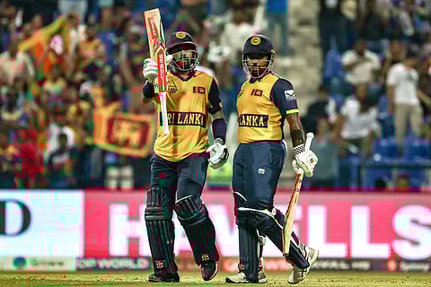 Sri Lanka's Kusal Mendis (L) celebrates after scoring a half-century (50 runs) as his captain Charith Asalanka looks on during the Asia Cup 2025 Twenty20 international cricket match against Afghanistan at the Sheikh Zayed Cricket Stadium in Abu Dhabi on September 18, 2025.