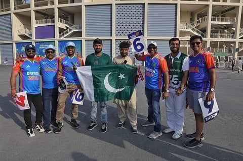 Fans pose before entering the stadium in Dubai.