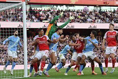 Manchester City's Italian goalkeeper Gianluigi Donnarumma reaches for the ball during the English Premier League football match against Arsenal at the Emirates Stadium in London on September 21, 2025.