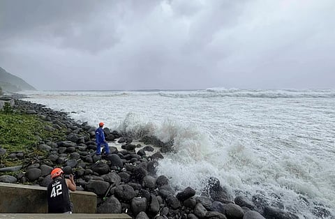 People watch as strong waves batter Basco, Batanes province, northern Philippines as Typhoon Ragasa affects the area on Monday, Sept. 22, 2025.