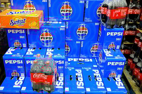 Bottles of Pepsi and Coca Cola are seen on sale in a discount supermarket in Union, New Jersey, on September 22, 2025.