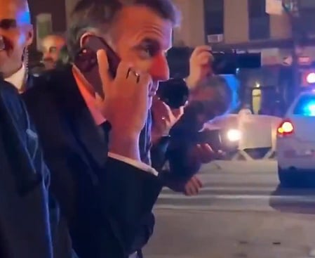 BFMTV footage shows Macron told police he couldn’t cross due to an incoming motorcade.