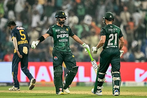 Pakistan's Hussain Talat chats with Mohammad Nawaz during the Asia Cup 2025 Super Four Twenty20 international cricket match against Sri Lanka at the Zayed Cricket Stadium in Abu Dhabi on September 23, 2025.