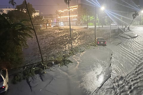 Stranded cars are seen as mud covers a neighbourhood after water from a burst landslide dam flooded the area in Hualien on September 23, 2025, as a result of heavy rain due to Super Typhoon Ragasa.