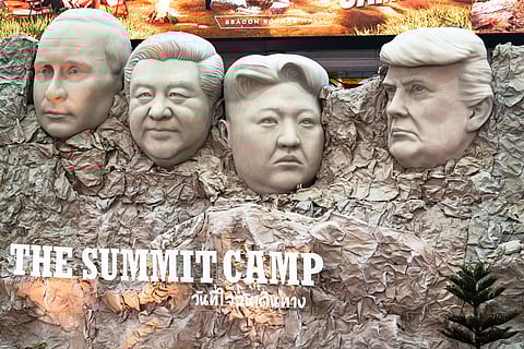 A parody Mount Rushmore sculpture depicts the faces of Russia's President Vladimir Putin (L), China's President Xi Jinping (2nd L), North Korea's leader Kim Jong-un (2nd R), and US President Donald Trump (R) at "The Summit Camp" camping and outdoors experience at a shopping mall in Bangkok.