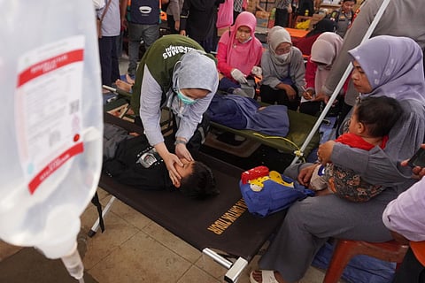 Health workers examine children who fell ill from food poisoning, at Cililin Hospital in West Bandung, Indonesia, Thursday, Sept. 25, 2025. (AP Photo/Adnan Kheruma) (Photo: AP)