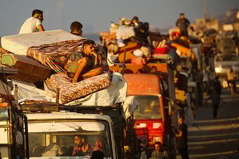 Displaced Palestinians with their belongings move southward along a road in Nuseirat, in the central Gaza Strip, on September 24, 2025, amid the Israel-Hamas war.