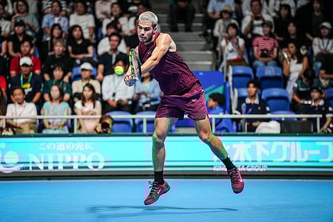 Spain’s Carlos Alcaraz hits a return against Argentina’s Sebastian Baez during their men’s singles round-of-32 match at the ATP Japan Open tennis tournament in Tokyo on September 25, 2025.