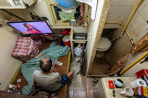 FILE - A resident who gave his name as Cheung watches television at his subdivided flat in Sham Shui Po district of Hong Kong, Feb. 6, 2025. (AP Photo/Chan Long Hei, File)
