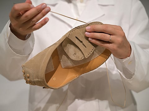 A worker sews by hand an iconic mocassin Tod's on the sidelines of Tod's collection show at Milan's Fashion Week Womenswear Spring / Summer 2026, on September 26, 2025 in Milan.