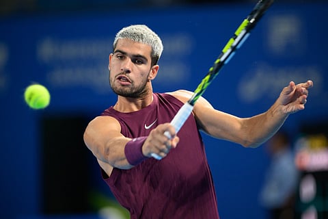 Spain's Carlos Alcaraz hits a return against USA's Brandon Nakashima during their men’s singles match at the ATP Japan Open tennis tournament in Tokyo on September 28, 2025.