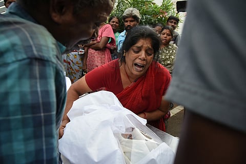 Relatives mourn after receiving the dead body of a victim who was killed in a stampede that broke out during a campaign rally Saturday evening in the Karur district, in the Indian state of Tamil Nadu, on September 28, 2025.