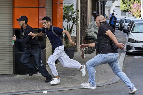 A member of Morocco's security forces disperses protesters during a youth-led demonstration for social justice and demanding improvements in the public health and education sectors, in front of the parliament building in Rabat, on September 28, 2025.