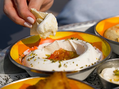 it’s a strained yogurt that offers a higher protein content than regular yogurt, which provides around 6-9 grams of protein.