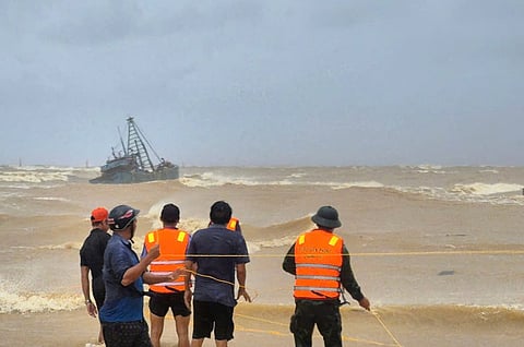 People work to rescue fishermen on a stranded fishing boat due to Typhoon Bualoi in Quang Tri, Vietnam Sunday, Sept. 28, 2025.