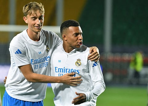Real Madrid's Spanish defender #24 Dean Huijsen (L) and Real Madrid's French forward #10 Kylian Mbappe (R) take part in a training session on the eve of the team's UEFA Champions League first round day 2 football match between Real Madrid (ESP) and Kairat Almaty (KAZ), at Almaty Ortalyk stadion in Almaty on September 29, 2025.