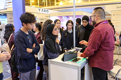 High school students discussing education opportunities with university representatives at Edufair Abu Dhabi